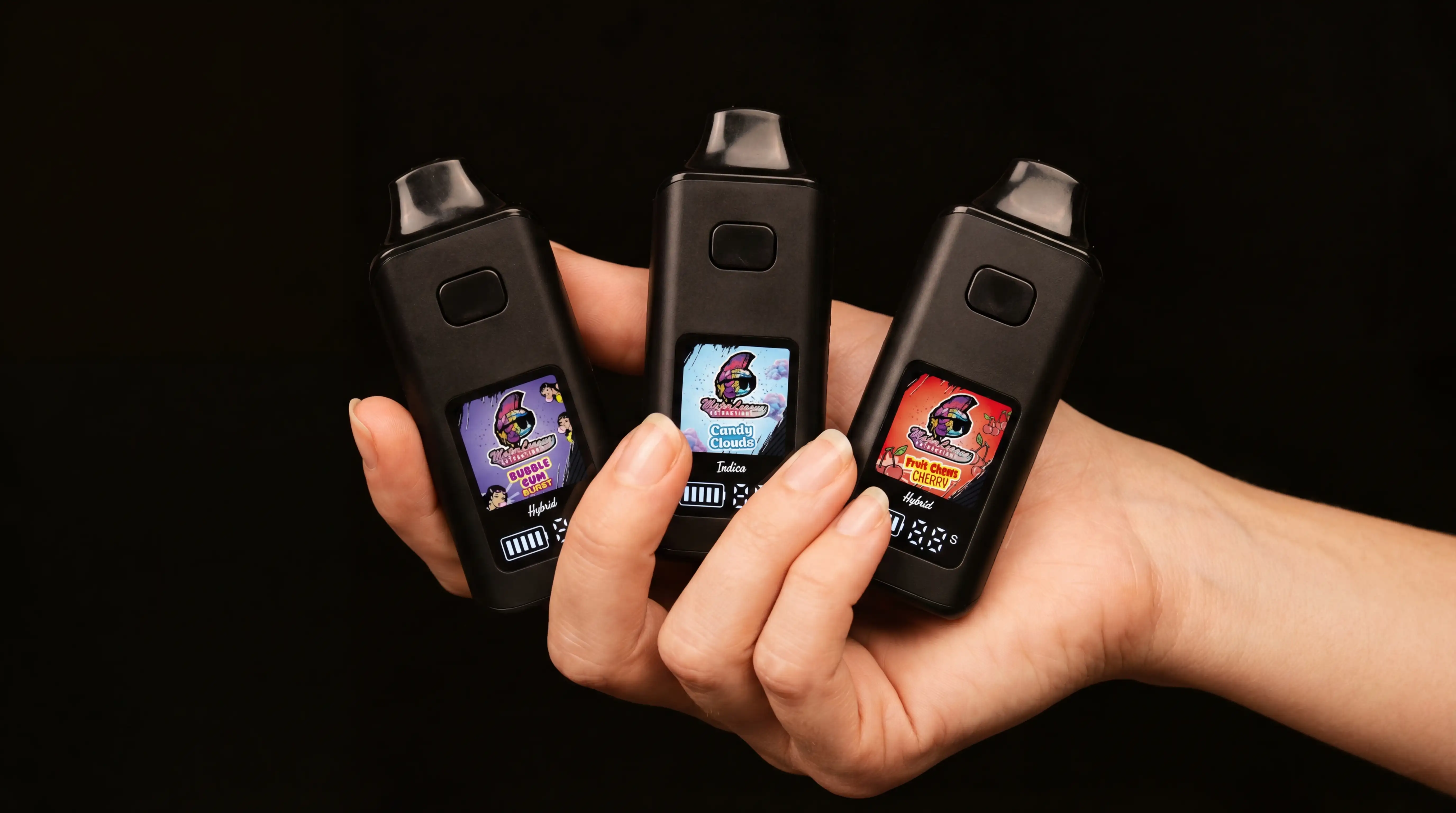 Major League Extractions vape devices held in hand showing three flavors with colorful display screens